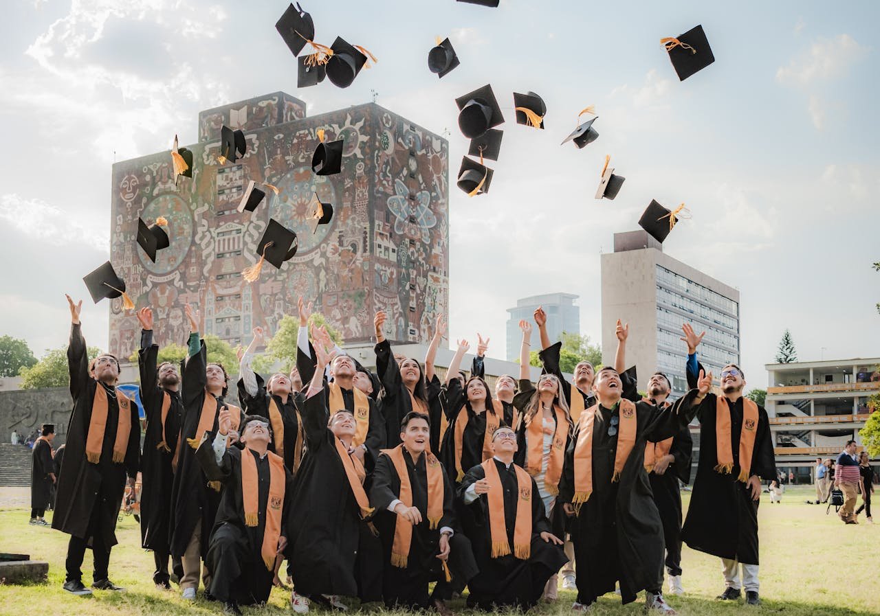 brand-02 Graduates joyfully toss hats in the air by UNAM Central Library in Mexico City.